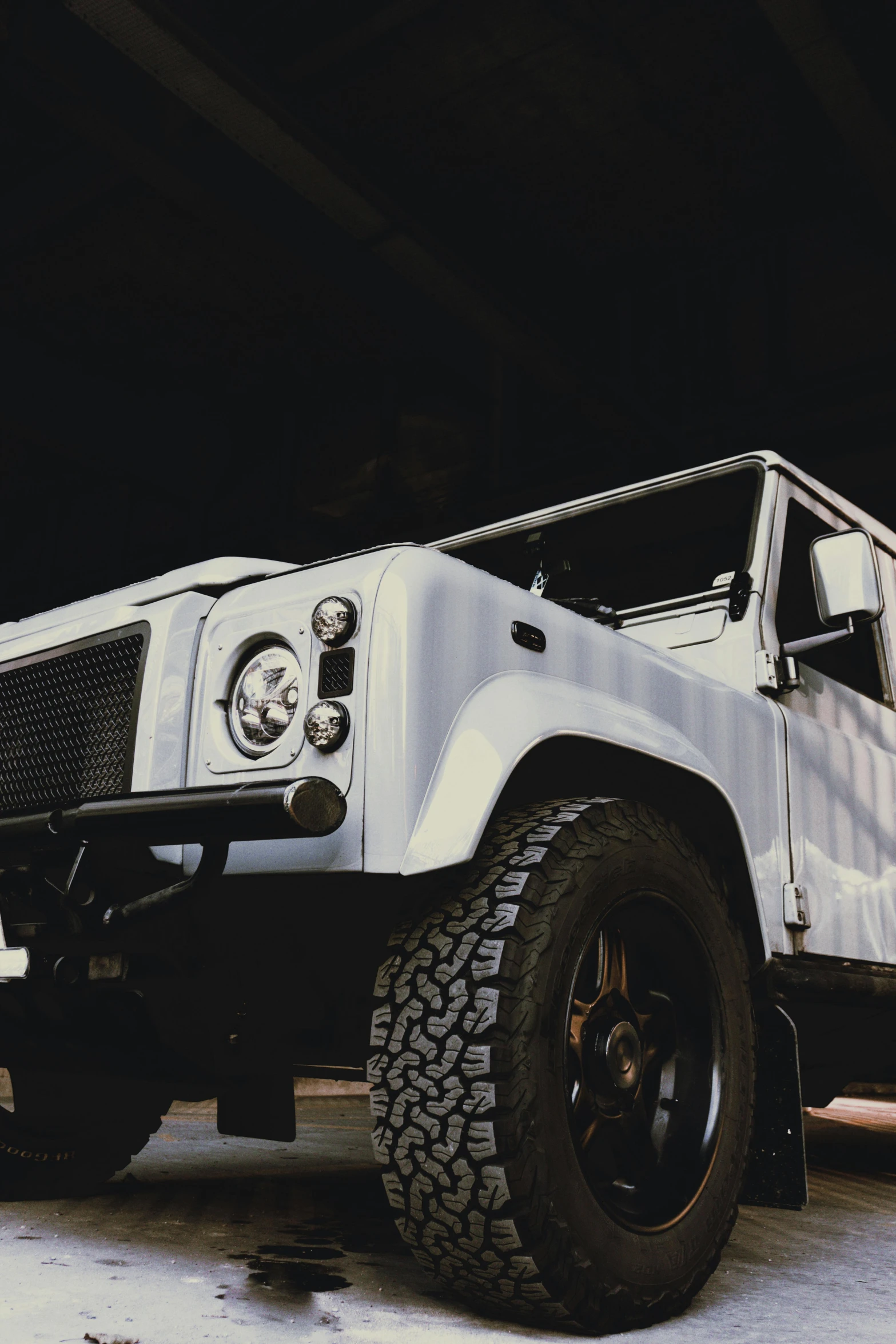 a white jeep truck is parked in the parking garage