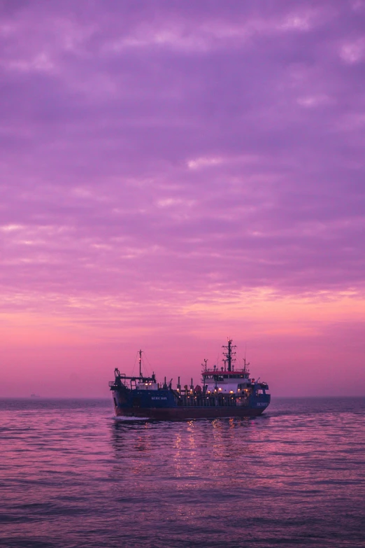 a large boat floating on top of a body of water, pexels contest winner, romanticism, purple beautiful sky, black sea, pink hues, sri lanka