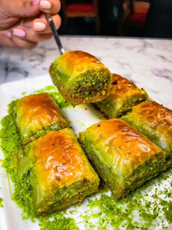 a close up of a plate of food on a table, girih, puffy, some green, profile image