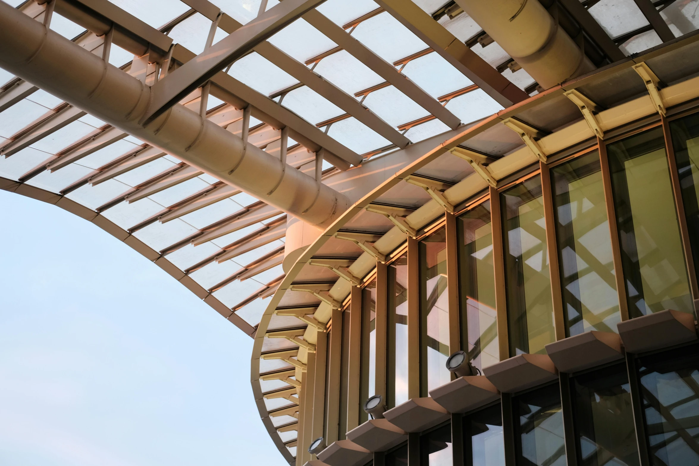 a curved metal structure is seen under the sun