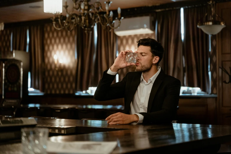 a man sitting at a bar drinking from a glass, pexels contest winner, renaissance, hydration, lightly dressed, crystal water, business