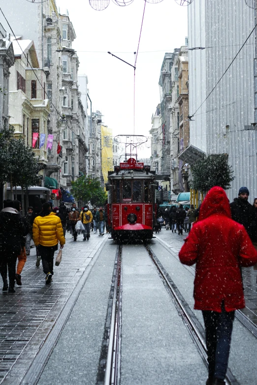 a trolley car riding on a rainy day