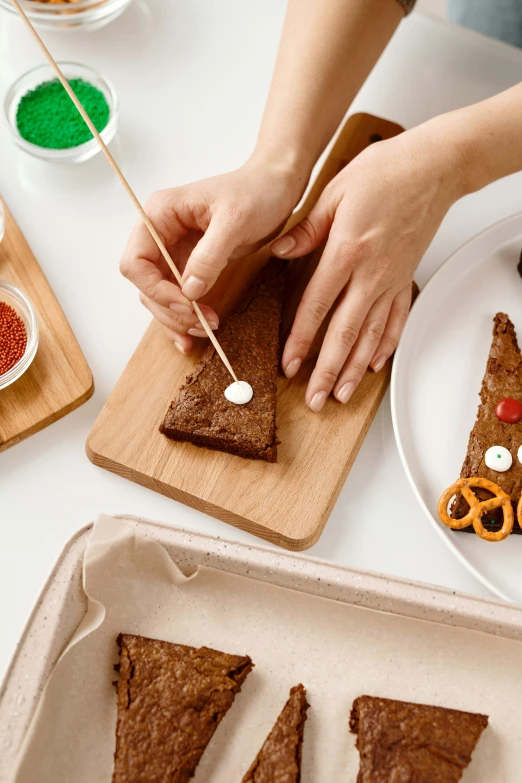 a close up of a person cutting food on a cutting board, candy decorations, detailed product image, bark, zoomed in