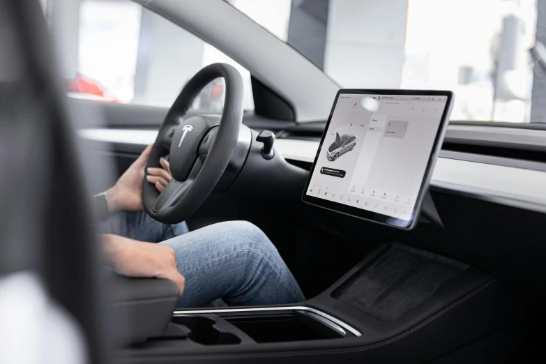 a person in a car holding a tablet