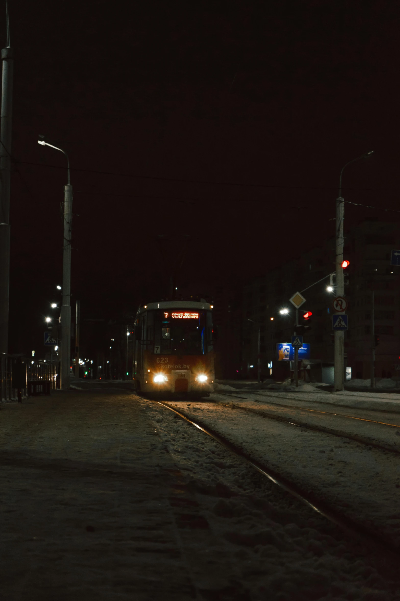 a light and tracks on a snowy road