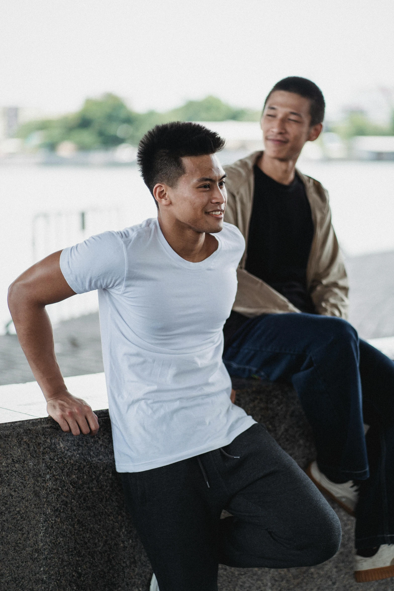 a couple of men sitting next to each other, wearing tight shirt, japanese collection product, hydration, dressed in a white t shirt