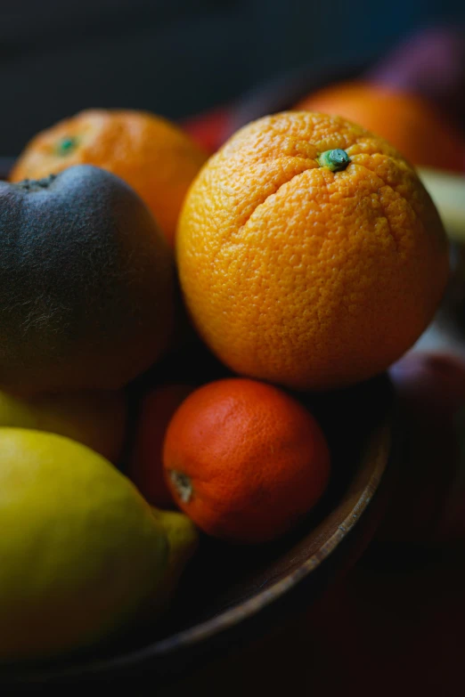 a close up of a bowl of fruit on a table, dark orange, multiple colors, bay area, oranges