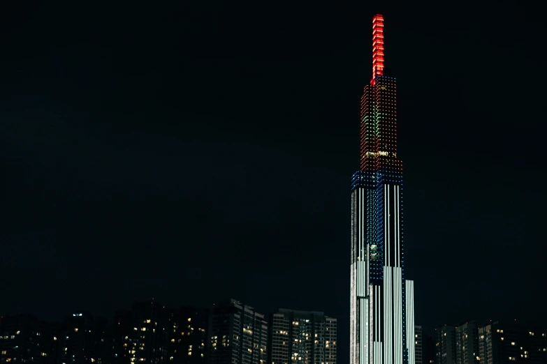 a very tall clock tower at night with many lights