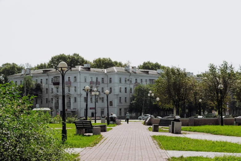 a walkway in front of a large white building, inspired by Illarion Pryanishnikov, unsplash, socialist realism, city park, фото девушка курит, square, city panorama