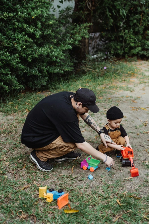 a man playing with a child in a yard, unsplash, realism, toys, streetwear, instagram photo, portrait image