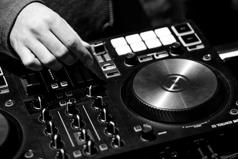 a close up of a person using a dj controller, a black and white photo, by Julia Pishtar, panel, high quality upload, uploaded, gaming