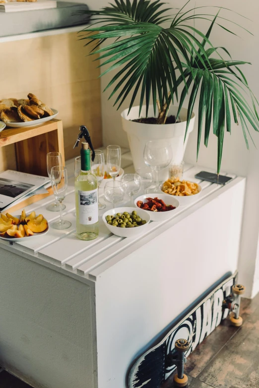 a buffet is lined up with glasses of wine