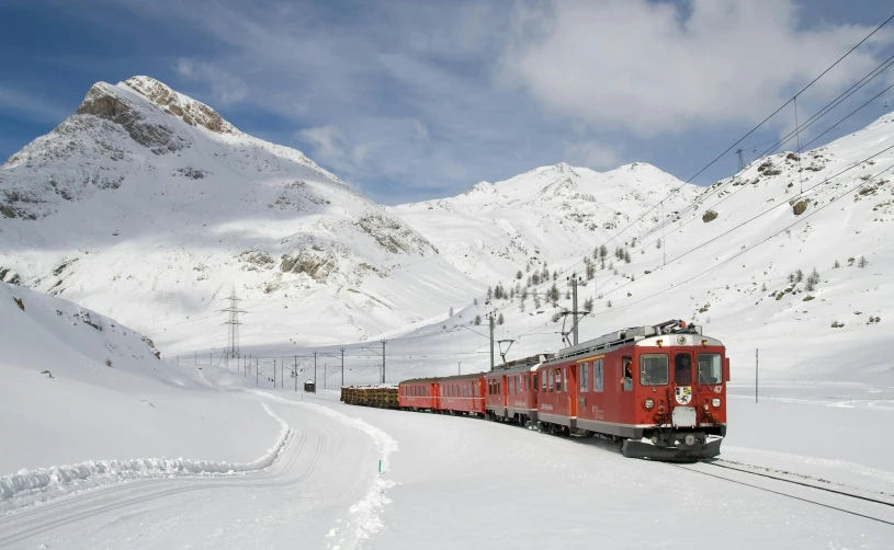 a large long red train on a steel track, by Werner Andermatt, pexels contest winner, snow capped mountains, panels, 🚿🗝📝