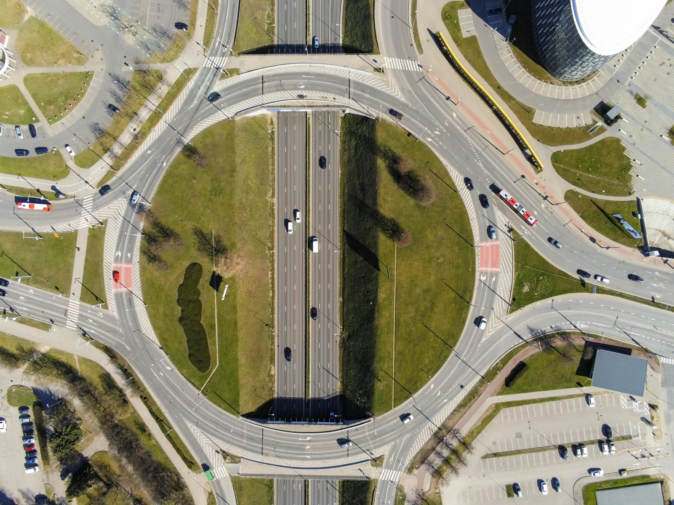 an aerial view of an intersection in a city, by Adam Marczyński, pexels contest winner, photorealism, circular towers, highway, thumbnail, square