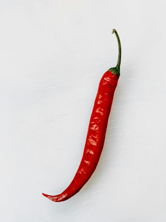 a red chili sitting on top of a white surface, inspired by Jan Müller, unsplash, 2 5 6 x 2 5 6 pixels, tall thin, longque chen, detailed product image