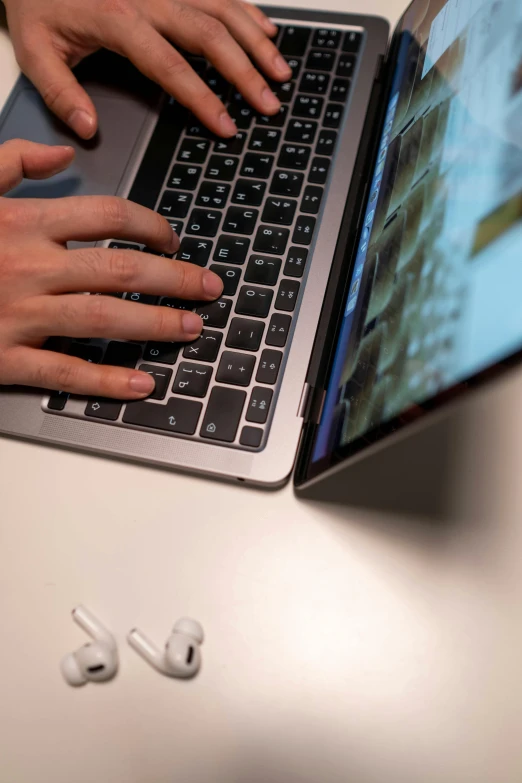 a close up of a person typing on a laptop, by Carey Morris, apple, thumbnail, dynamic angled shot, zoom