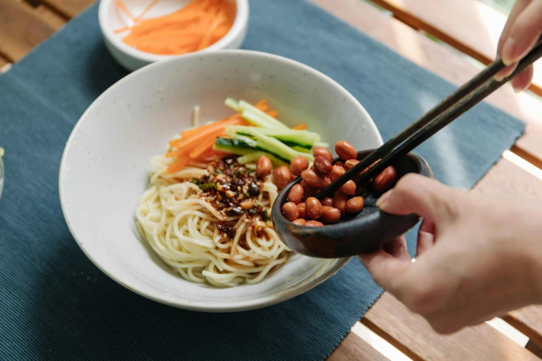 a person holding chopsticks over a bowl of food, beans, changquan, profile image, fan favorite