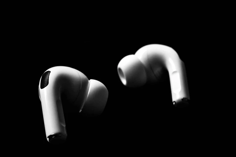 a pair of earphones sitting on top of a table, a black and white photo, pexels, purism, white on black, diverse medical cybersuits, apple design, aircraft