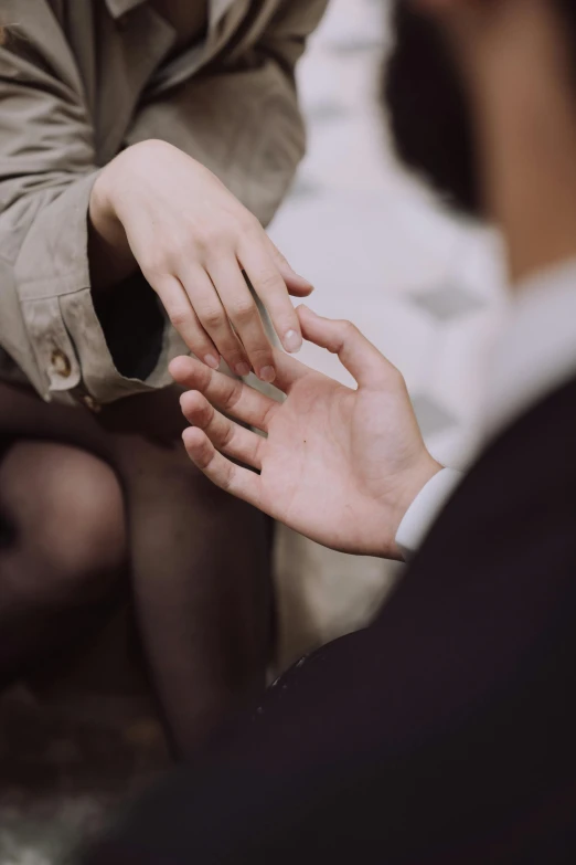 a person reaching out their hand with another person behind them