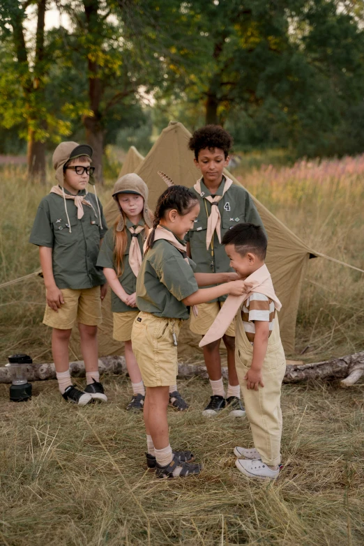 a group of young boys standing next to each other, inspired by Wes Anderson, trending on unsplash, girl wearing uniform, encampment, canopee, tan