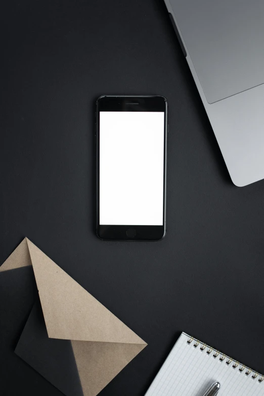 a cell phone sitting on top of a desk next to a laptop, by Sven Erixson, trending on pexels, postminimalism, matte black paper, square, 15081959 21121991 01012000 4k, ios app icon