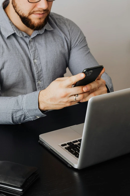 a man sitting at a table using a cell phone, trending on pexels, sitting at a computer, grey, corporate phone app icon, lgbtq