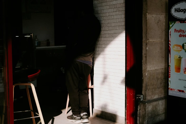 a person standing at the door of a restaurant