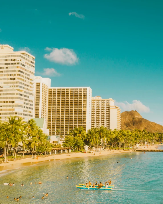 a group of people swimming in a body of water, big buildings, hawaii beach, standing on a beach