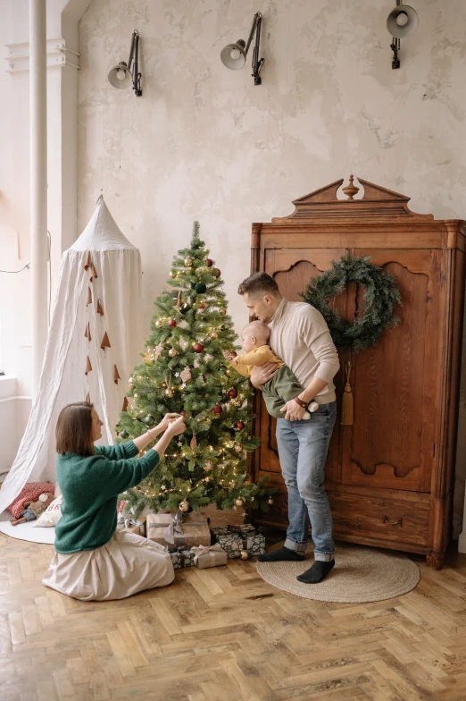 man and a little girl decorating a christmas tree