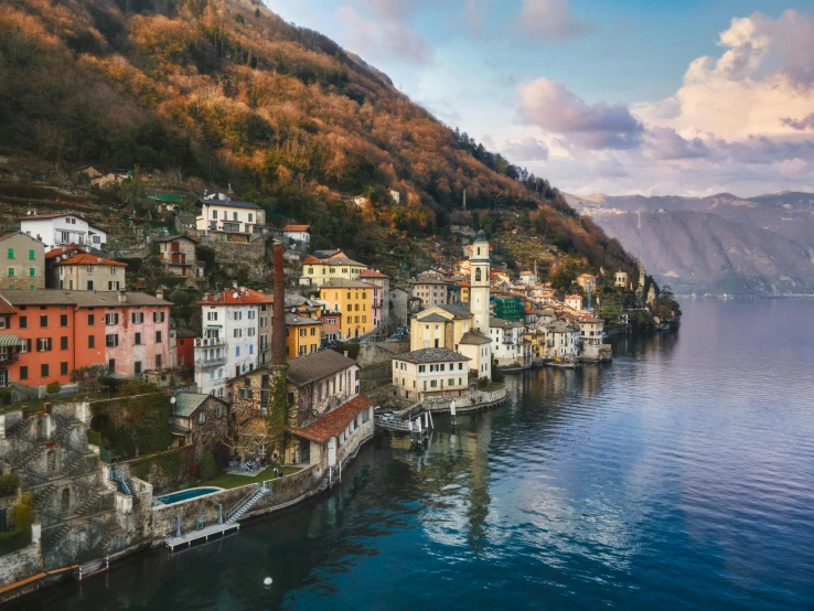 a small town on the edge of a body of water, by Carlo Martini, pexels contest winner, renaissance, boka, lush scenery, thumbnail, muted colors. ue 5