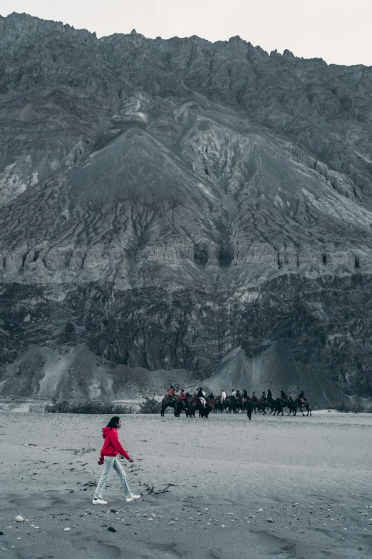 a child is running and other people are on horses in the distance