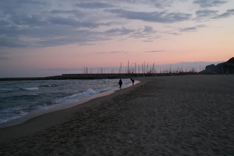 a couple of people walking along a beach next to the ocean, a picture, by Jan Tengnagel, pexels contest winner, venice at dusk, 2 5 6 x 2 5 6 pixels, taken in the mid 2000s, waking up