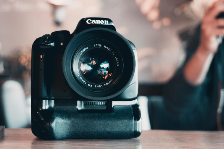 a camera sitting on top of a wooden table, by Carey Morris, pexels contest winner, canon dslr, 🦩🪐🐞👩🏻🦳, zoomed in shots, home video footage