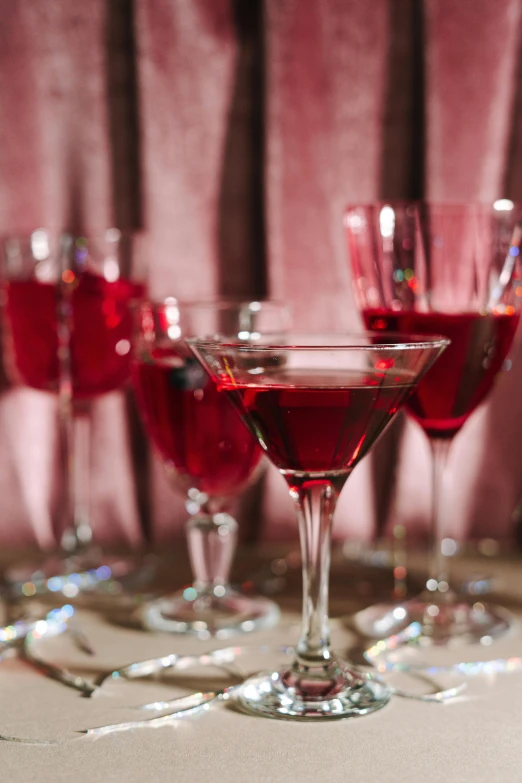 a glass of cocktail sitting on top of a counter