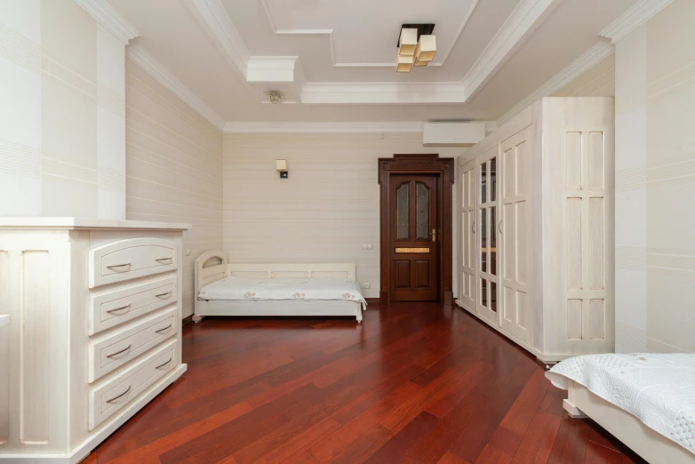 a bed room with white walls and a wooden floor