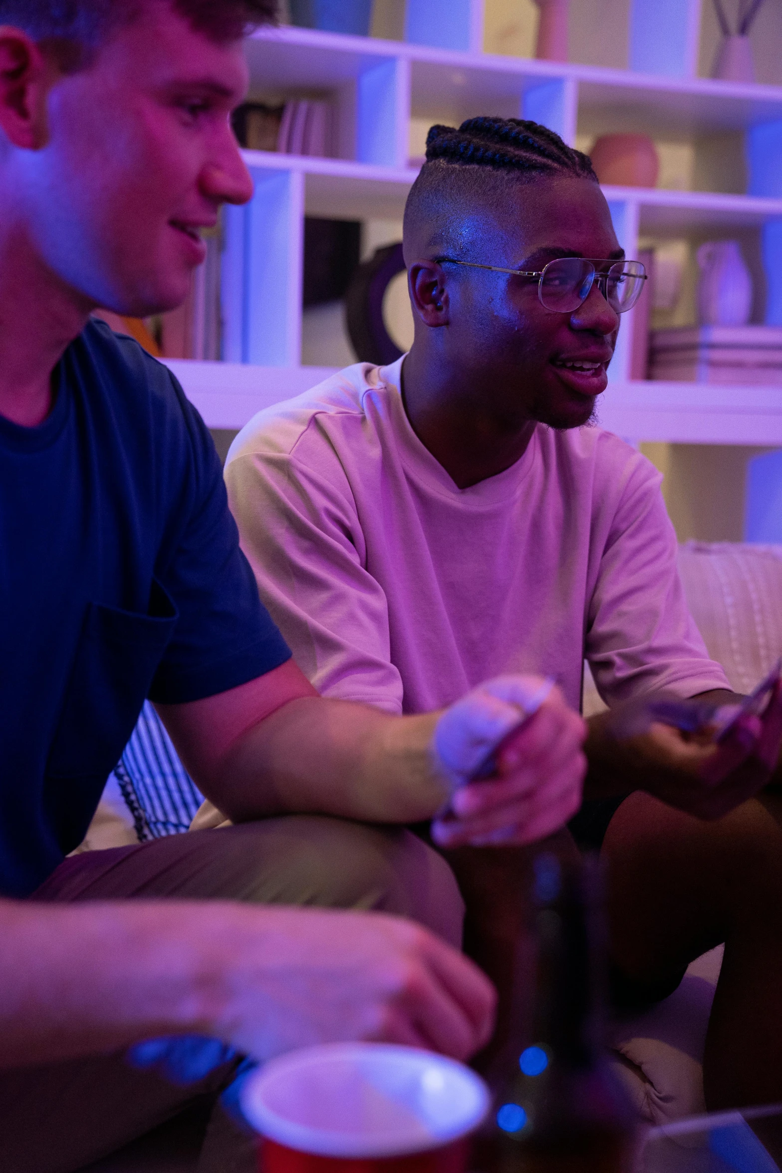 three men sitting on a couch playing a video game, pexels, blue and purple lighting, samsung smartthings, technicolour 1, talking