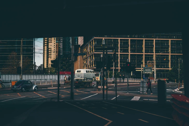 a street filled with lots of traffic next to tall buildings, a picture, unsplash contest winner, australian tonalism, bus stop, panoramic anamorphic, kombi, harsh shadows and reflections