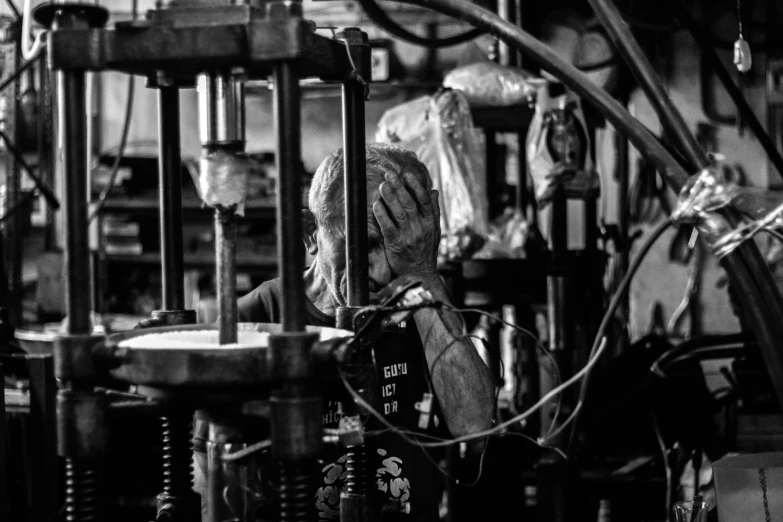 a man working on a machine in a factory, a portrait, pexels contest winner, assemblage, hear no evil, monochrome:-2, leaking, ears