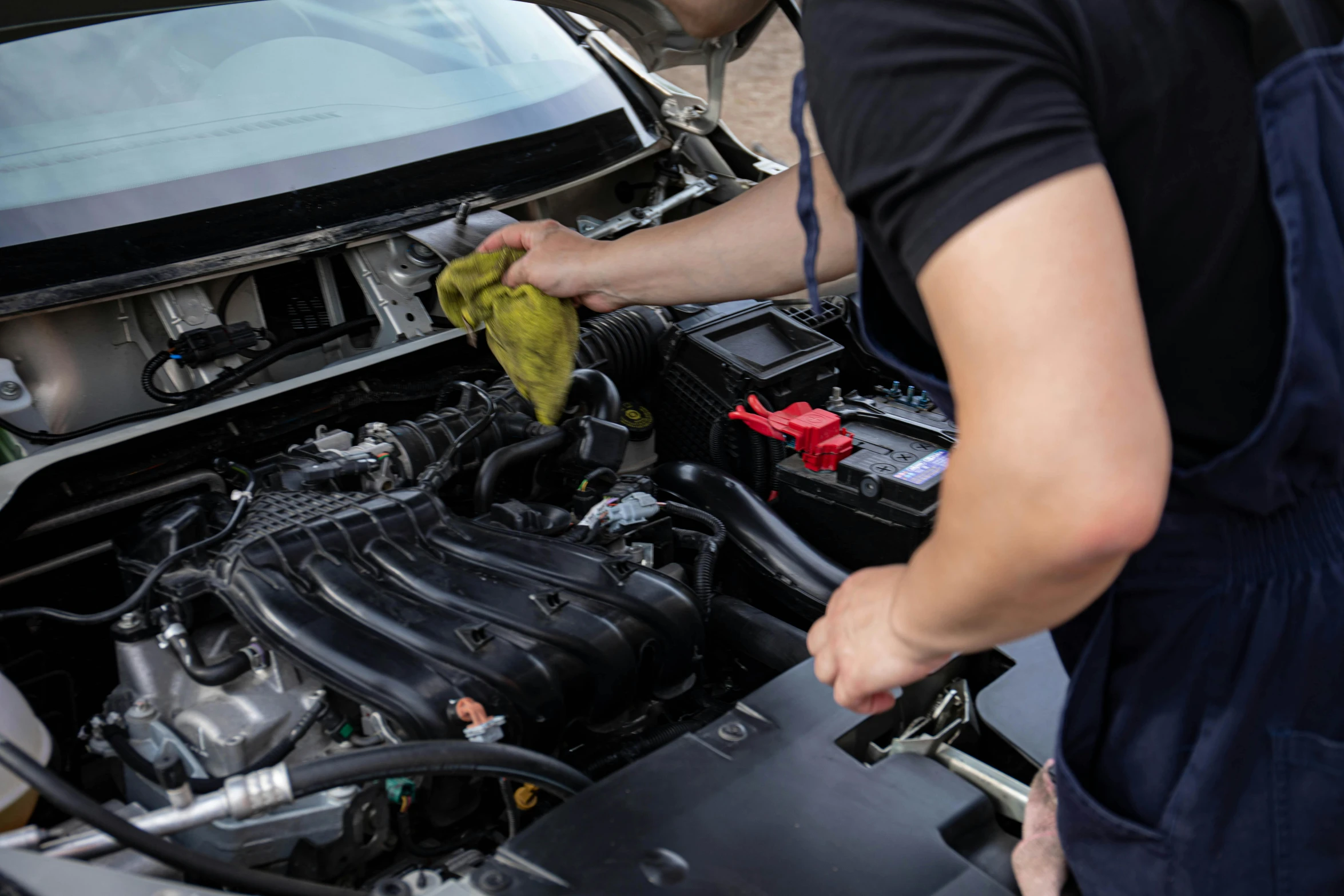 a man is cleaning the engine of a car, by Daniel Lieske, shutterstock, 15081959 21121991 01012000 4k, instagram post, rectangle, graphic print