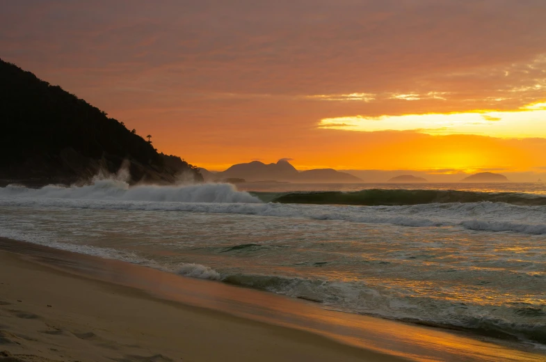 a man riding a surfboard on top of a sandy beach, by Peter Churcher, unsplash contest winner, sunset panorama, rio de janeiro, warm coloured, abel tasman