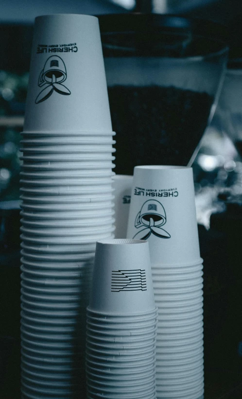 a stack of white cups sitting on top of a counter, a cartoon, unsplash, plasticien, low quality photo, engraved, zombie coffee logo, cinestill 800t 50mm