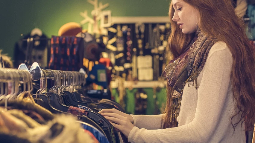 the woman in the store is browsing for clothing