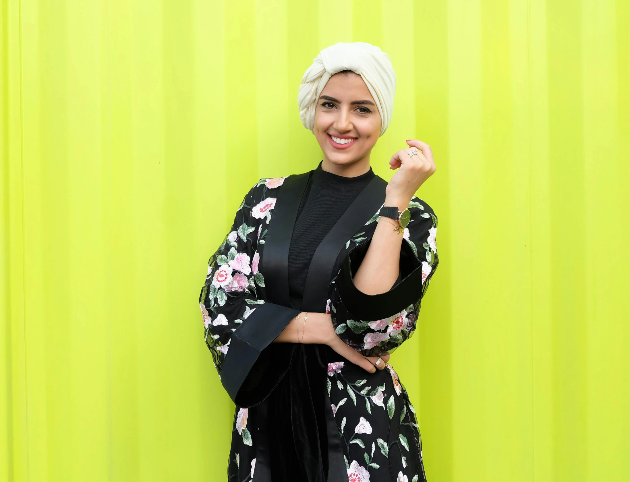 a woman standing in front of a green wall, inspired by Maryam Hashemi, hurufiyya, wearing black silk robe, with a happy expression, girl with short white hair, competition winning