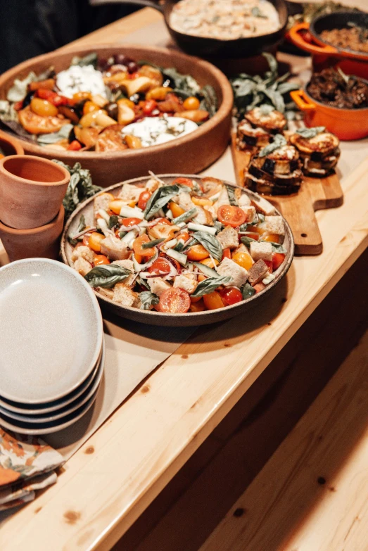 a wooden table topped with plates and bowls of food, by Daniel Lieske, unsplash, ratatouille style, holiday, multiple stories, full frame image