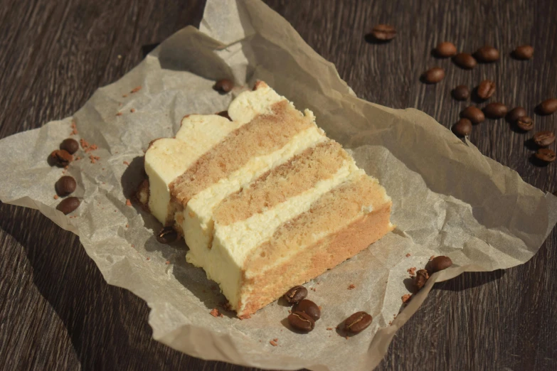 a piece of cake sitting on top of a piece of wax paper, celebration of coffee products, multiple layers, sandstone, high quality product image”