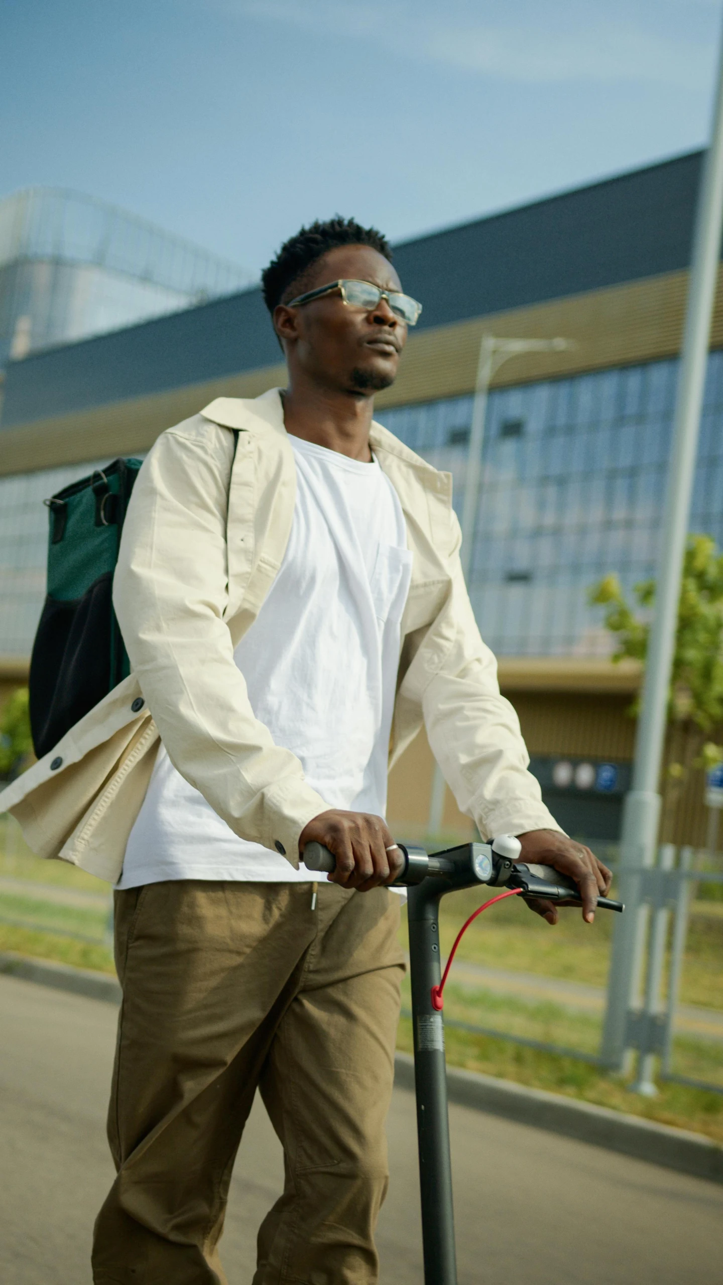 a man riding a scooter on a city street, pexels, happening, wearing lab coat and glasses, a man wearing a backpack, avatar image, mkbhd