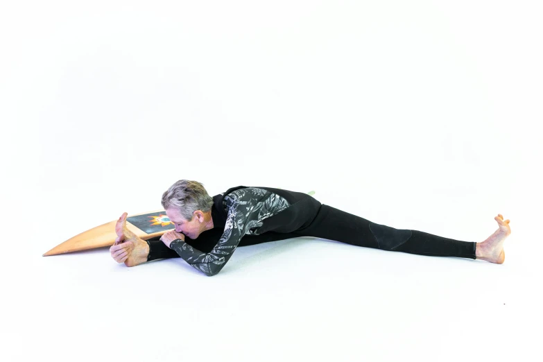 a man laying on the ground with a surfboard, by Alison Watt, black spandex, multi-part, pulling the move'derp banshee ', corner