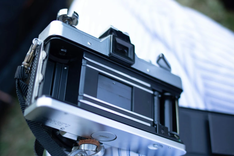 a close up of a person holding a camera, a picture, large format film camera, low - angle shot from behind, panoramic photography, fujifilm velvia