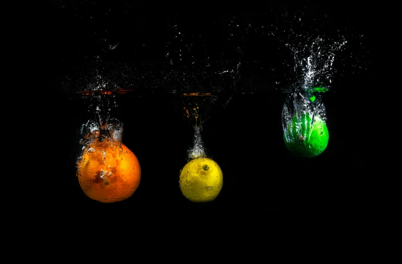 a group of fruit that are in the water, an album cover, by Doug Ohlson, pexels, art photography, illuminated orbs, three colors, an orange, shot on sony alpha dslr-a300