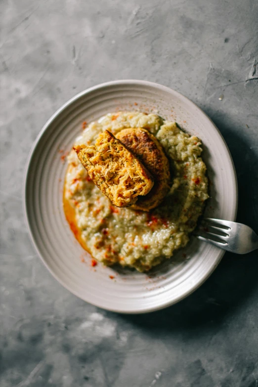 a close up of a plate of food on a table, by Carey Morris, unsplash, mashed potatoes, paprika, eggplant, square